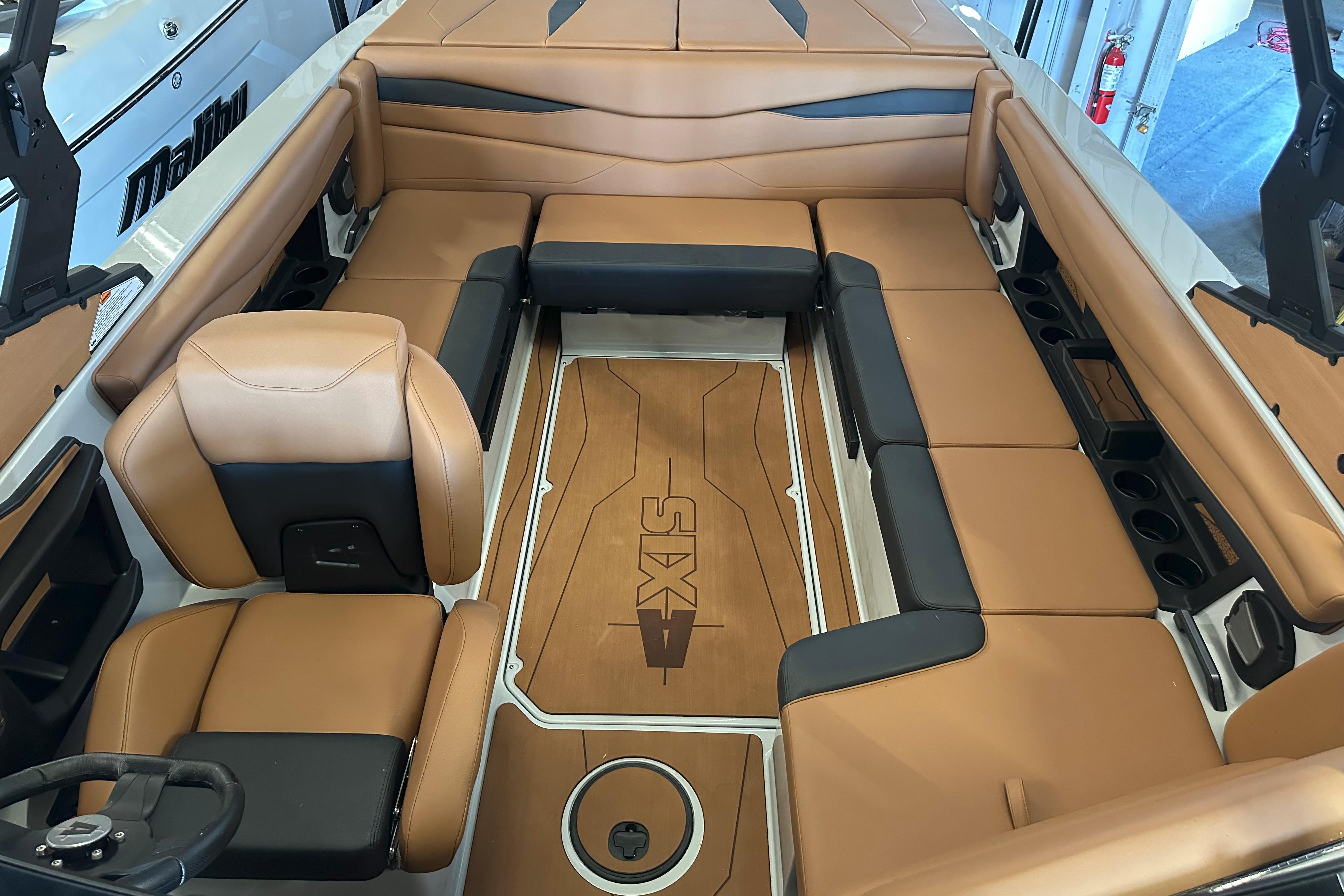 2026 Axis A225 boat interior with tan and black seating, featuring a stylish deck design.