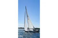 Sailboat CR 400 DS 2002 gliding on blue water under clear sky.