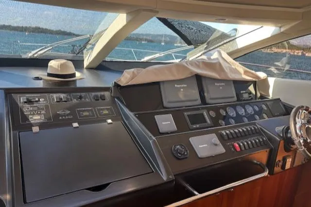 Joško Marić Yacht Photos Pics Cockpit of 2008 Sunseeker Predator 72 yacht with navigation controls and a hat.