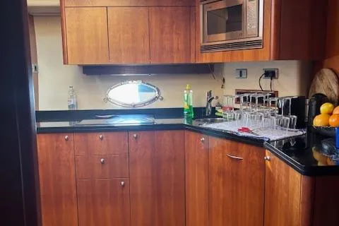 Joško Marić Yacht Photos Pics Luxurious kitchen interior of 2008 Sunseeker Predator 72 yacht with wooden cabinets and modern appliances.