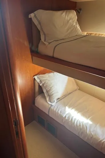 Joško Marić Yacht Photos Pics Bunk beds in 2008 Sunseeker Predator 72 yacht cabin, featuring wooden interior and cozy bedding.
