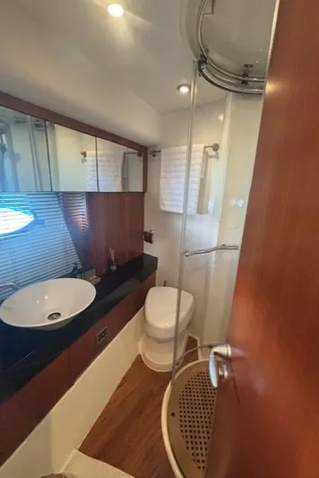 Joško Marić Yacht Photos Pics Luxurious bathroom in 2008 Sunseeker Predator 72 yacht with modern fixtures and wood accents.