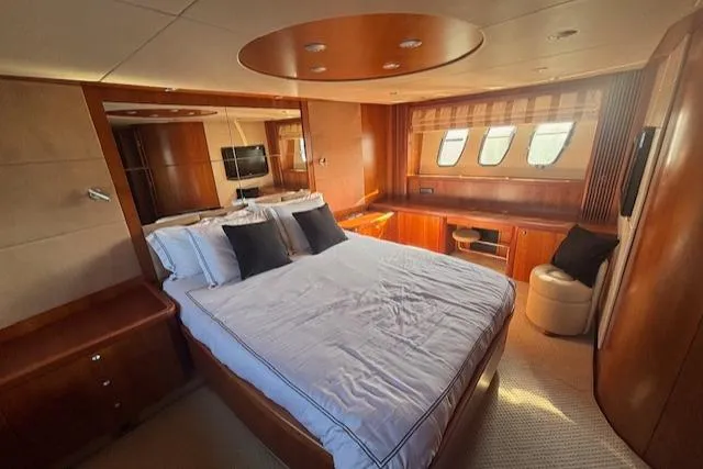 Joško Marić Yacht Photos Pics Luxurious 2008 Sunseeker Predator 72 yacht bedroom with elegant wood finishes and large windows.