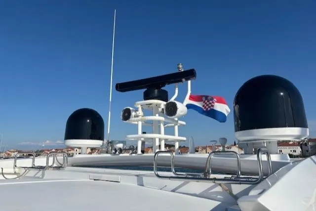 Joško Marić Yacht Photos Pics Sunseeker Predator 72 yacht, 2008 model, with radar and Croatian flag against clear sky.