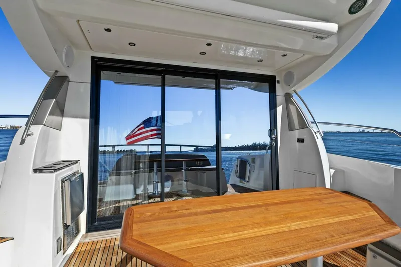 Slainte Yacht Photos Pics Prestige 450 S 2014 yacht deck with wooden table and ocean view.