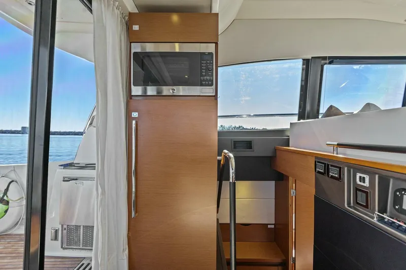 Slainte Yacht Photos Pics Interior of 2014 Prestige 450 S yacht with modern kitchen appliances and scenic window view.