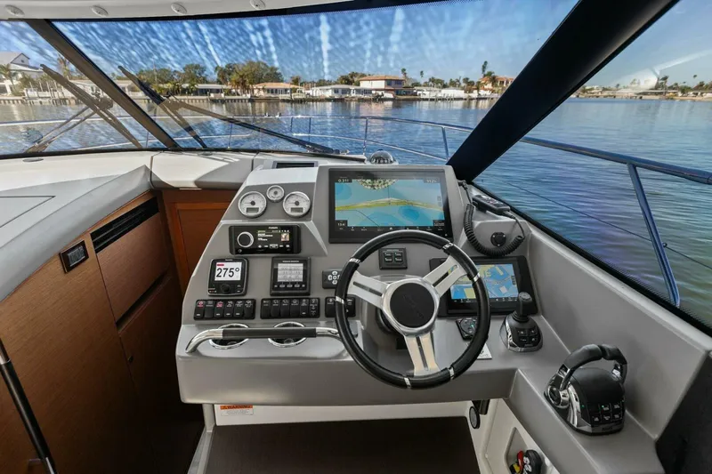 Slainte Yacht Photos Pics Prestige 450 S 2014 yacht cockpit with navigation controls and waterfront view.