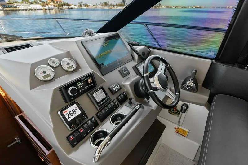 Slainte Yacht Photos Pics Prestige 450 S 2014 yacht helm with modern controls and scenic water view.