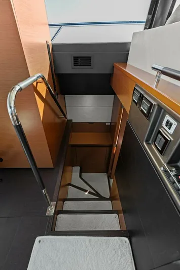 Slainte Yacht Photos Pics Interior stairs of a 2014 Prestige 450 S yacht, featuring sleek design and modern controls.
