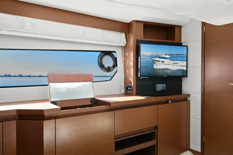 Slainte Yacht Photos Pics Interior of 2014 Prestige 450 S yacht with modern wood cabinetry and window view.