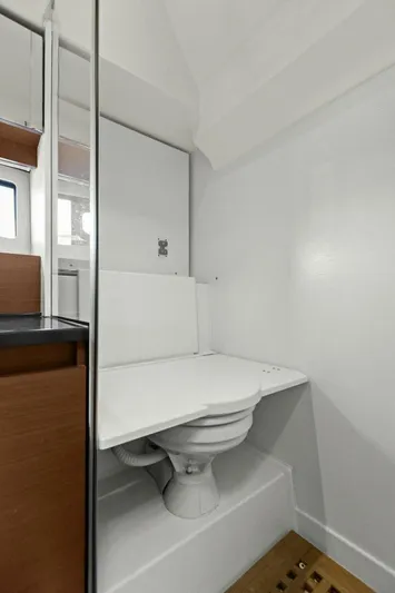 Slainte Yacht Photos Pics Compact bathroom in 2014 Prestige 450 S yacht with modern white fixtures.