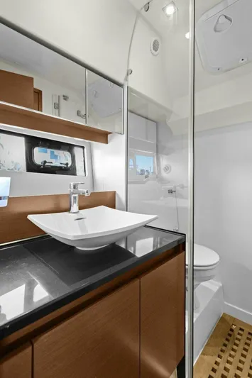 Slainte Yacht Photos Pics Luxurious bathroom in 2014 Prestige 450 S yacht with modern sink and wooden accents.