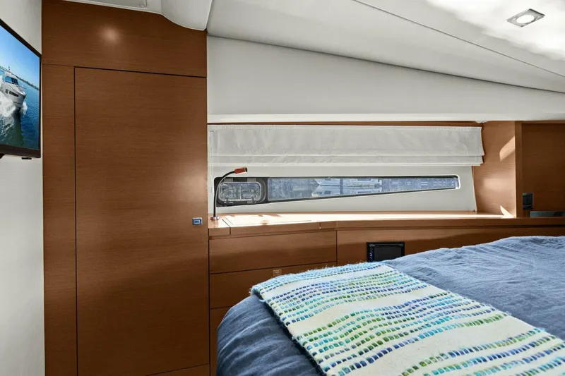 Slainte Yacht Photos Pics Luxurious interior of 2014 Prestige 450 S yacht with modern wood finish and cozy bedding.
