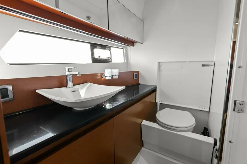 Slainte Yacht Photos Pics Luxurious bathroom in 2014 Prestige 450 S yacht with modern sink and toilet.