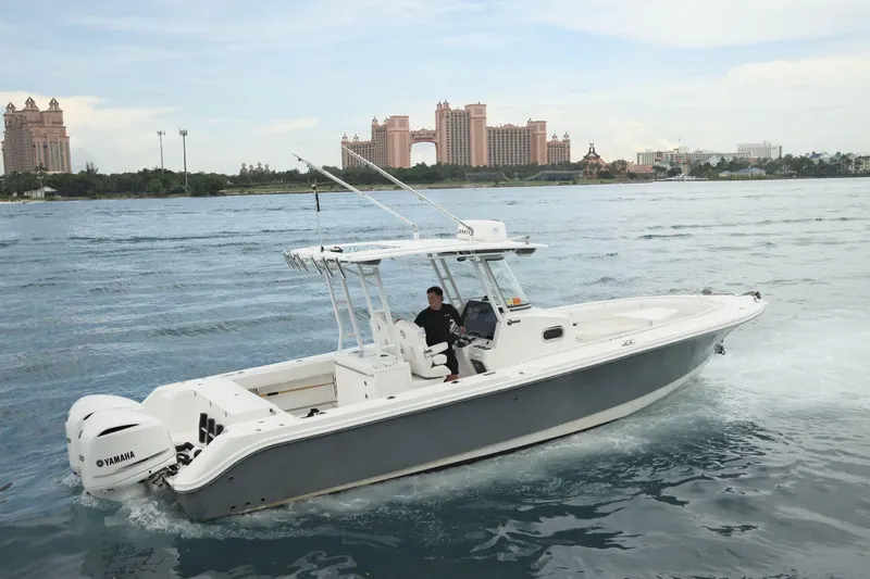  Yacht Photos Pics 2019 Edgewater Prince boat cruising near a coastal resort with Yamaha engines.