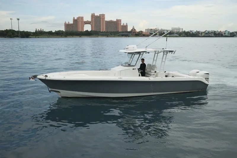  Yacht Photos Pics 2019 Edgewater Prince boat cruising on calm waters near a coastal cityscape.