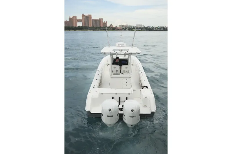  Yacht Photos Pics 2019 Edgewater Prince boat with dual engines on open water, cityscape in background.