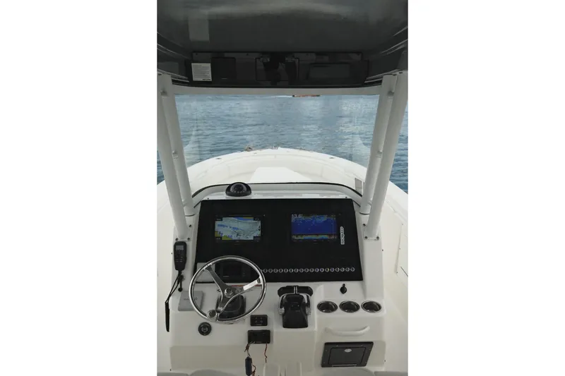  Yacht Photos Pics 2019 Edgewater Prince boat dashboard with navigation screens and steering wheel on open water.