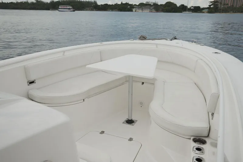 Yacht Photos Pics 2019 Edgewater Prince boat interior with white seating and table on calm water.