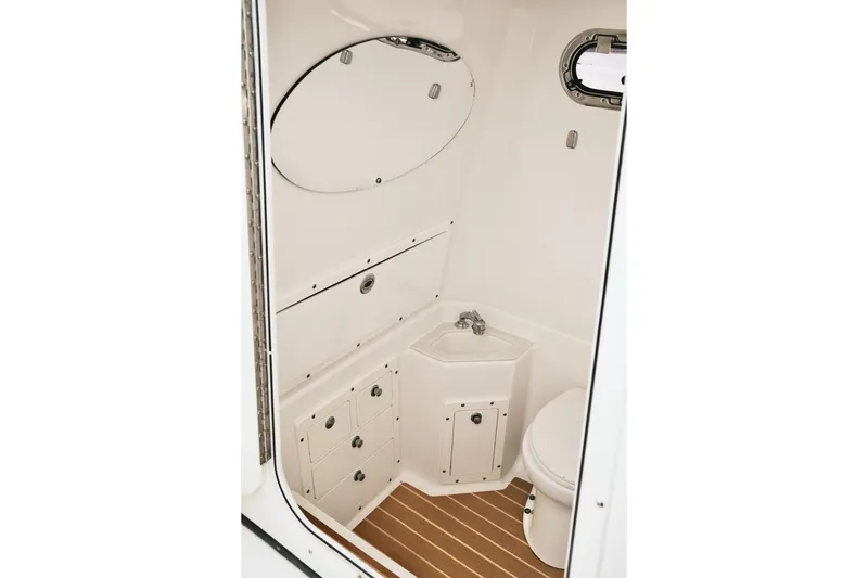  Yacht Photos Pics 2019 Edgewater Prince boat bathroom with sink, mirror, and wooden floor.