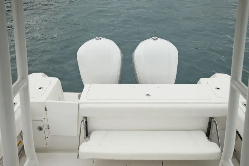  Yacht Photos Pics 2019 Edgewater Prince boat with dual outboard motors on calm water.