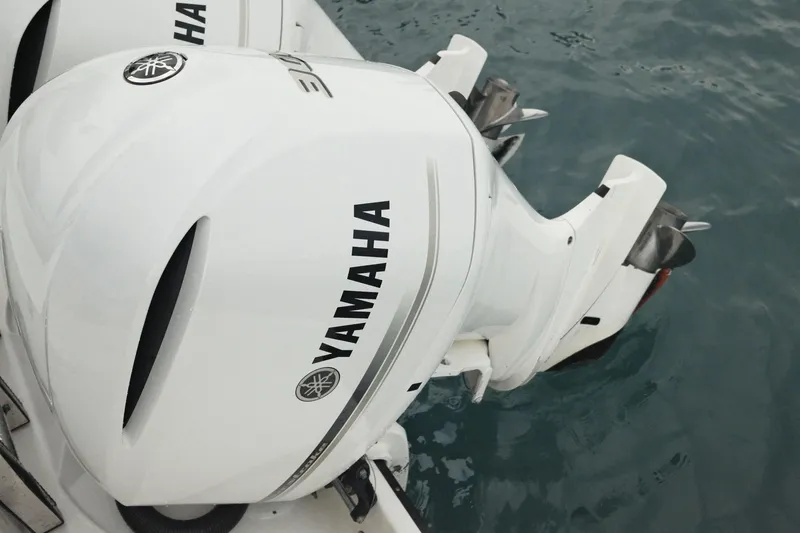  Yacht Photos Pics White Yamaha outboard motor on 2019 Edgewater Prince boat in water.