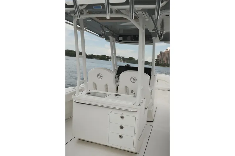  Yacht Photos Pics 2019 Edgewater Prince boat interior with seating and storage, overlooking a scenic waterfront.