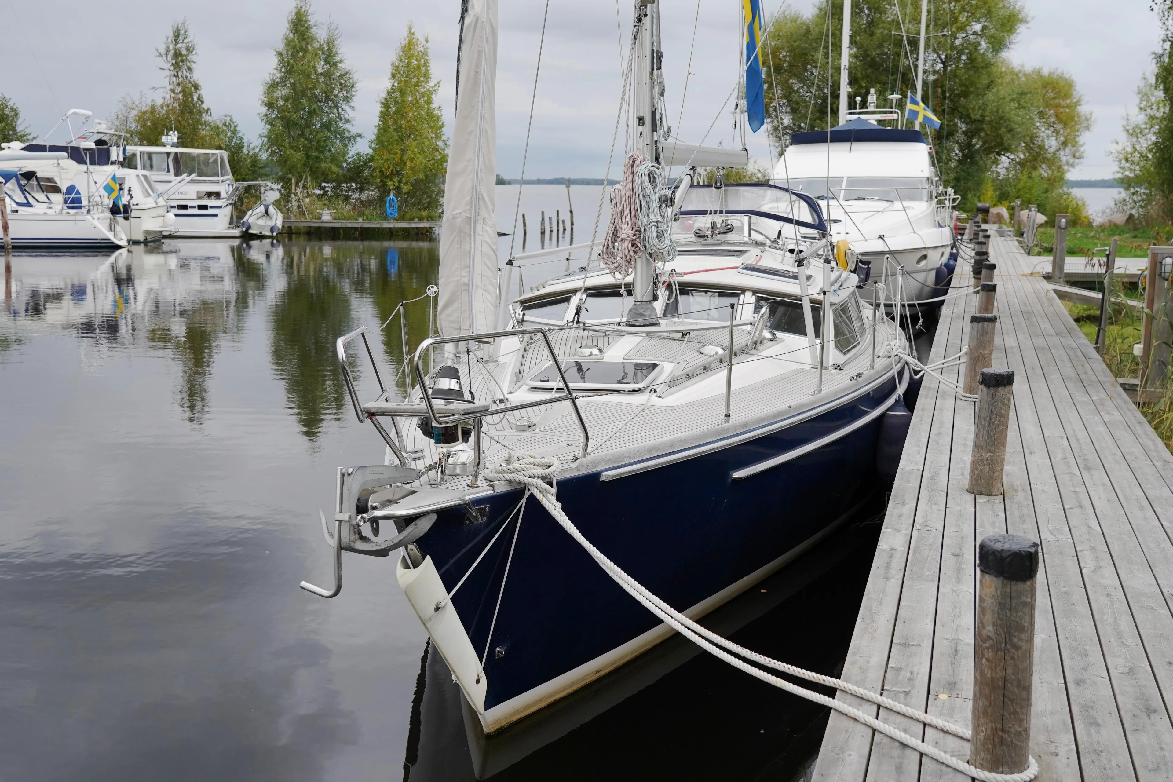 Sailboat docked at a serene marina, CR 400 DS, 2002 model.