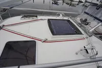 Sailboat deck with solar panel, CR 400 DS, 2002 model, docked at marina.