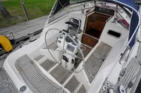 Cockpit of 2002 CR 400 DS sailboat with wooden flooring and steering wheel.