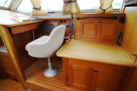 2002 CR 400 DS boat interior with wooden cabinetry and swivel chair.