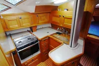 2002 CR 400 DS yacht interior kitchen with wooden cabinets and modern appliances.