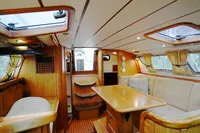 Luxurious interior of 2002 CR 400 DS yacht with wooden furnishings and cozy seating area.