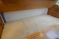 2002 CR 400 DS interior cabin with wooden finish and cushioned bed.