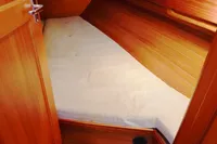 Cozy wooden cabin interior of 2002 CR 400 DS sailboat with mattress and door.