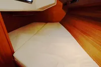 Cozy cabin interior of 2002 CR 400 DS with wooden paneling and cushioned bedding.
