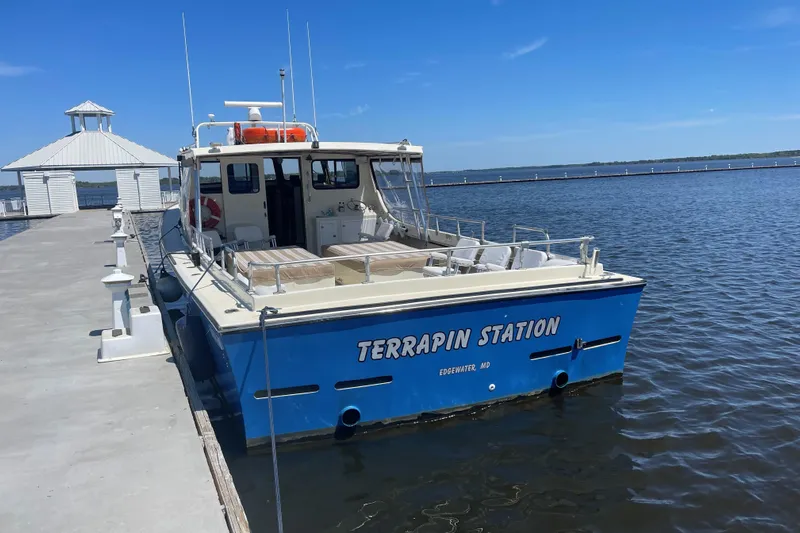 Terrapin Station Yacht Photos Pics Blue Carman 46 boat named "Terrapin Station" docked at a pier, sunny day.