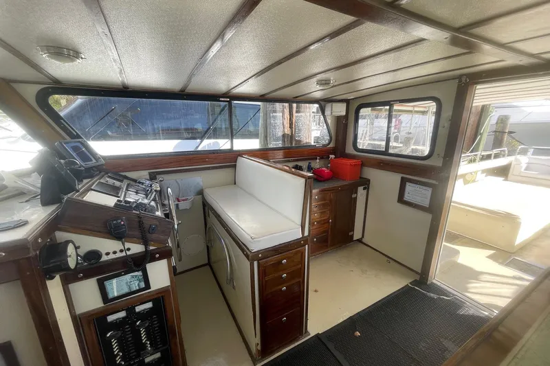 Terrapin Station Yacht Photos Pics Interior of a 2001 Carman 46 boat with wooden cabinetry and navigation equipment.