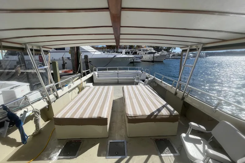 Terrapin Station Yacht Photos Pics Open deck of 2001 Carman 46 boat with striped cushions, docked at marina.