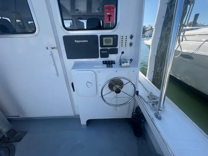  Yacht Photos Pics 2003 H&H Marine 42 Downeast boat helm with Raymarine equipment, docked at marina.