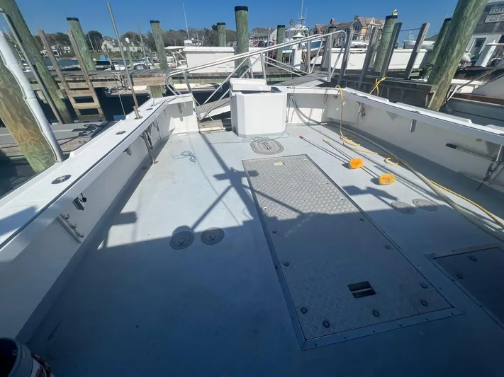  Yacht Photos Pics 2003 H&H Marine 42 Downeast boat deck with storage and railing at dock.