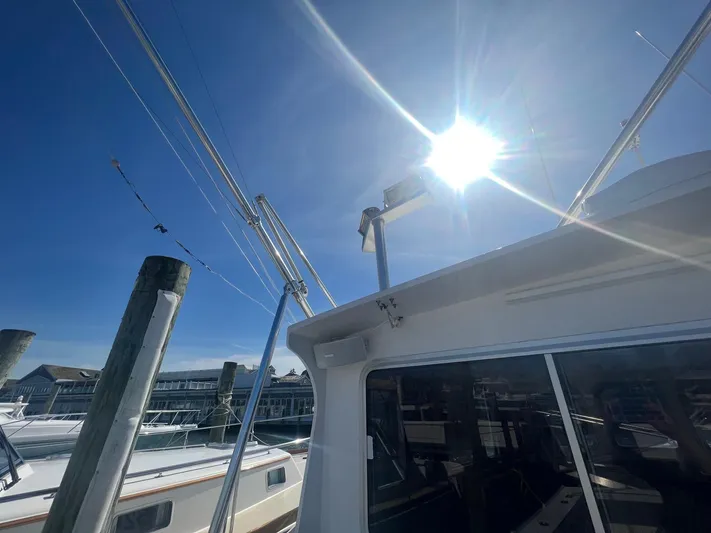  Yacht Photos Pics 2003 H&H Marine 42 Downeast boat under bright sun at marina.