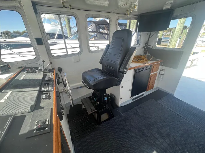  Yacht Photos Pics Interior of 2003 H&H Marine 42 Downeast boat with captain's chair and control panel.