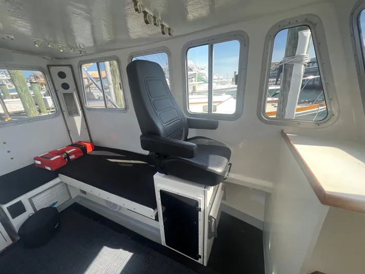  Yacht Photos Pics Interior of 2003 H&H Marine 42 Downeast boat with captain's chair and windows.