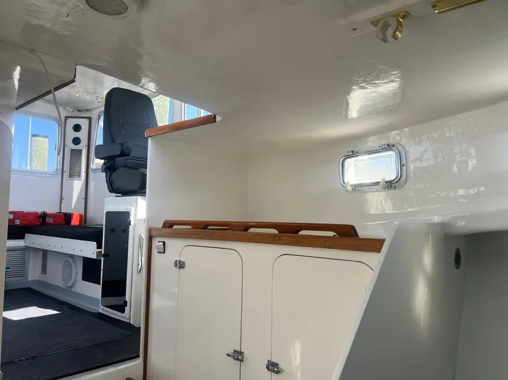  Yacht Photos Pics Interior of 2003 H&H Marine 42 Downeast boat, featuring seating and storage compartments.