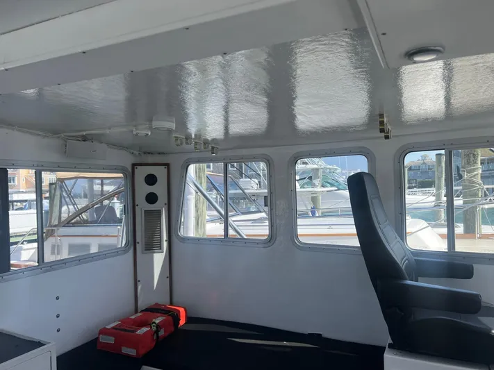  Yacht Photos Pics Interior of a 2003 H&H Marine 42 Downeast boat with windows and seating.