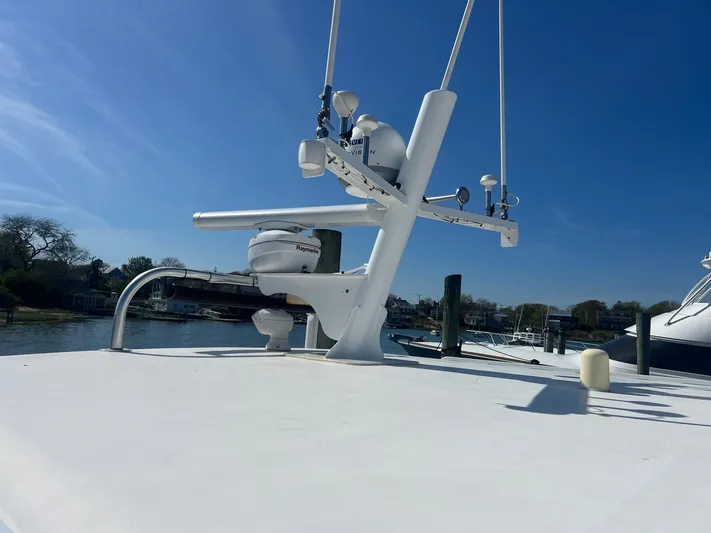  Yacht Photos Pics 2003 H&H Marine 42 Downeast boat deck with radar equipment under clear blue sky.