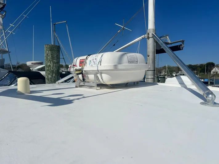  Yacht Photos Pics 2003 H&H Marine 42 Downeast boat deck with mounted life raft under clear blue sky.