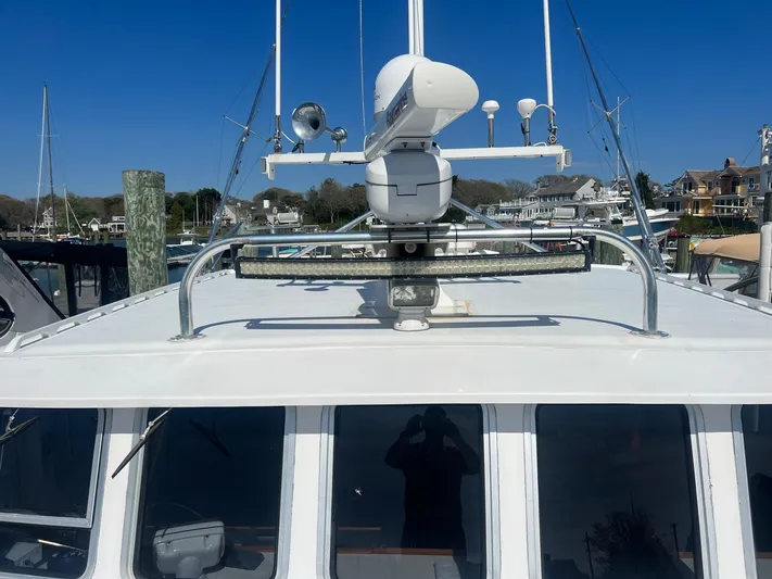  Yacht Photos Pics 2003 H&H Marine 42 Downeast boat with radar equipment, docked at a marina.