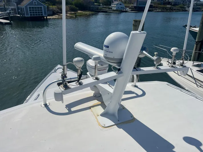  Yacht Photos Pics 2003 H&H Marine 42 Downeast boat with radar equipment, docked by waterfront homes.